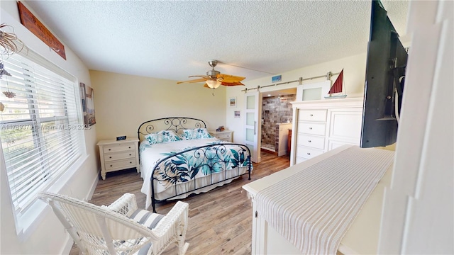 9681 Sunrise Lakes Blvd Unit 209, Sunrise, FL 33322 - bedroom featuring multiple windows, a textured ceiling, and light wood-type flooring