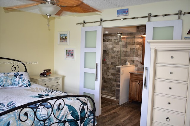 9681 Sunrise Lakes Blvd Unit 209, Sunrise, FL 33322 - bedroom featuring ensuite bathroom, dark wood-style floors, and a barn door