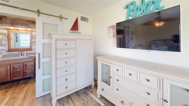9681 Sunrise Lakes Blvd Unit 209, Sunrise, FL 33322 - interior space featuring vanity, wood finished floors, visible vents, and a textured ceiling