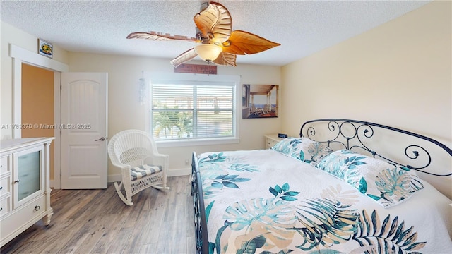 9681 Sunrise Lakes Blvd Unit 209, Sunrise, FL 33322 - bedroom featuring baseboards, a ceiling fan, wood finished floors, and a textured ceiling