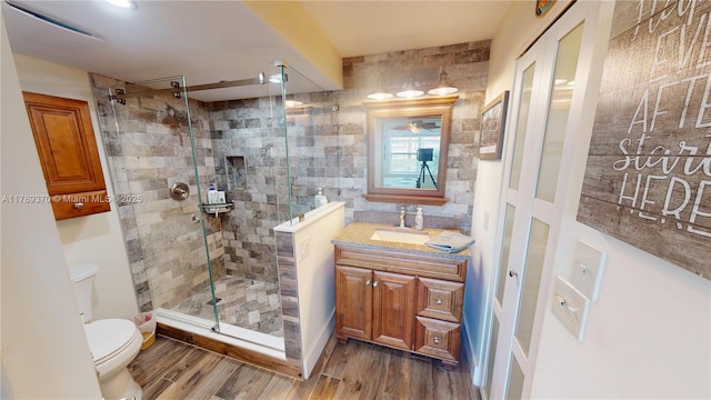 9681 Sunrise Lakes Blvd Unit 209, Sunrise, FL 33322 - bathroom with a shower stall, toilet, vanity, and wood finished floors