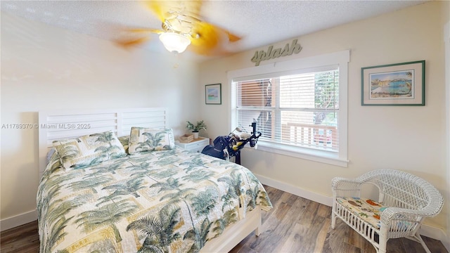 9681 Sunrise Lakes Blvd Unit 209, Sunrise, FL 33322 - bedroom with wood finished floors, baseboards, a textured ceiling, and ceiling fan