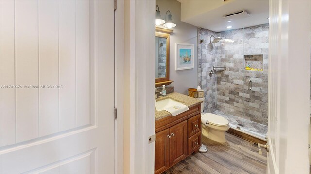 9681 Sunrise Lakes Blvd Unit 209, Sunrise, FL 33322 - full bathroom with wood finished floors, a stall shower, vanity, toilet, and visible vents