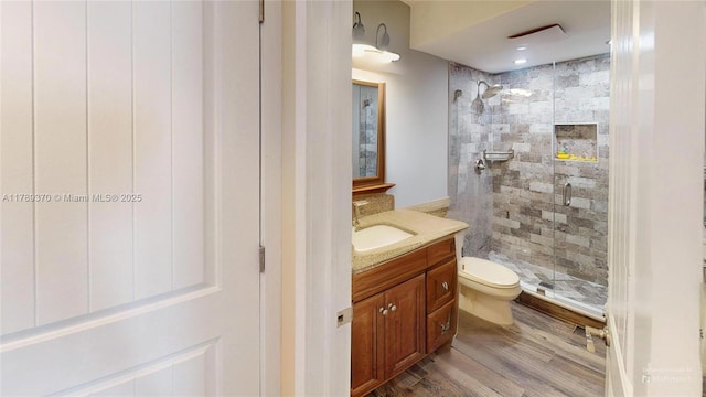 9681 Sunrise Lakes Blvd Unit 209, Sunrise, FL 33322 - bathroom featuring toilet, wood finished floors, vanity, and a stall shower