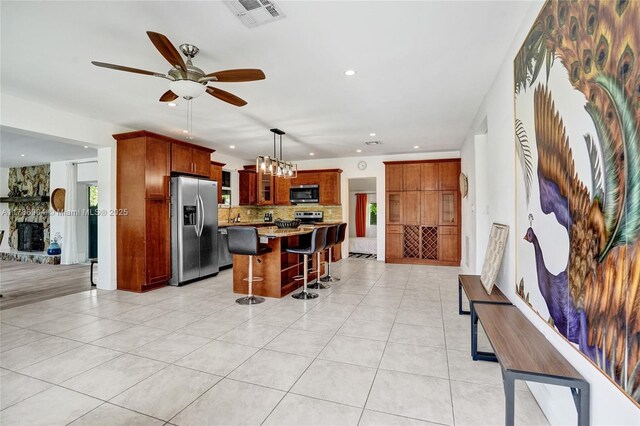 3411 SW 36th St, West Park, FL 33023 - kitchen featuring appliances with stainless steel finishes, backsplash, a ceiling fan, recessed lighting, and a breakfast bar area