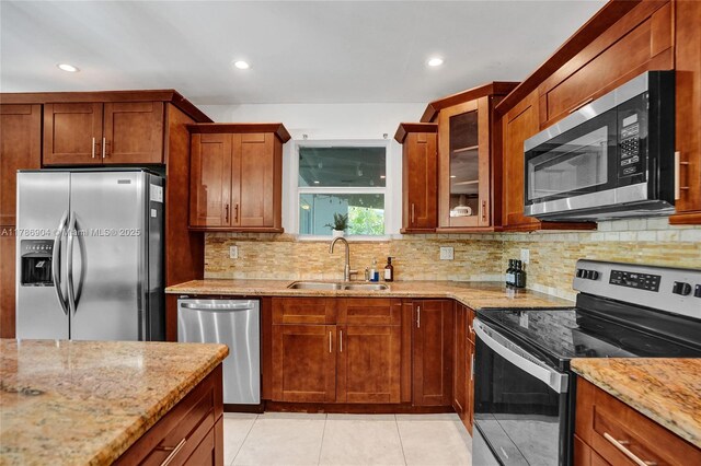 3411 SW 36th St, West Park, FL 33023 - kitchen with appliances with stainless steel finishes, light stone counters, tasteful backsplash, and recessed lighting