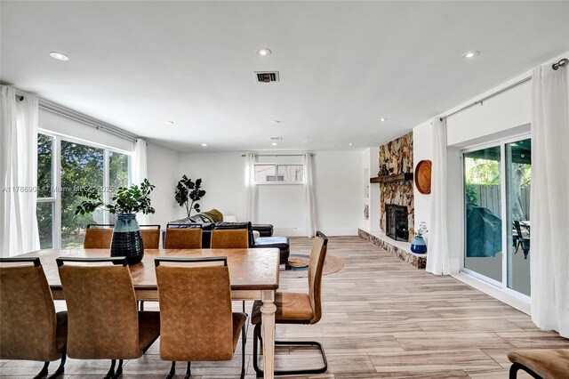 3411 SW 36th St, West Park, FL 33023 - dining area featuring plenty of natural light, a fireplace, recessed lighting, and light wood-style flooring