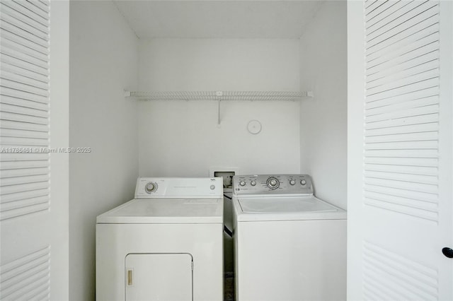 laundry room with washer and clothes dryer and laundry area