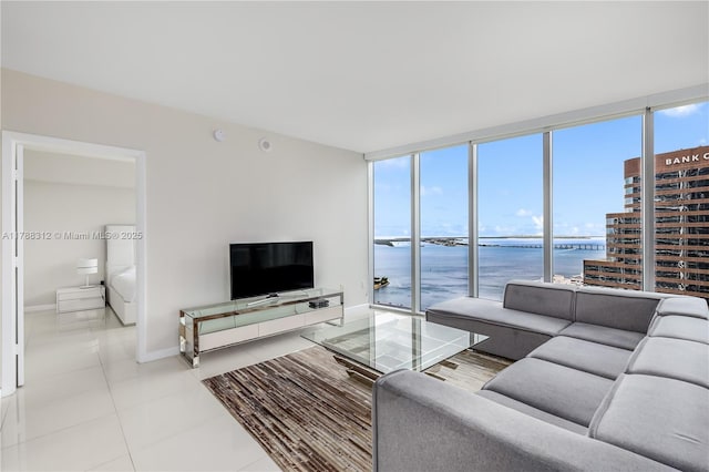 living area with baseboards, floor to ceiling windows, and tile patterned flooring