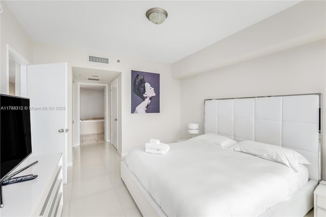 bedroom featuring light tile patterned flooring, visible vents, and baseboards
