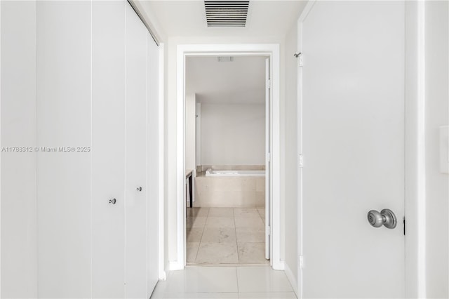 corridor with light tile patterned flooring and visible vents