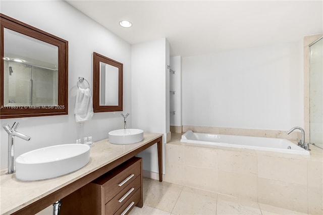 full bath featuring a garden tub, an enclosed shower, tile patterned flooring, and a sink