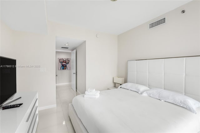 bedroom with baseboards, visible vents, and light tile patterned floors