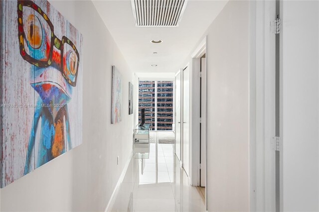corridor with recessed lighting, visible vents, and light tile patterned floors
