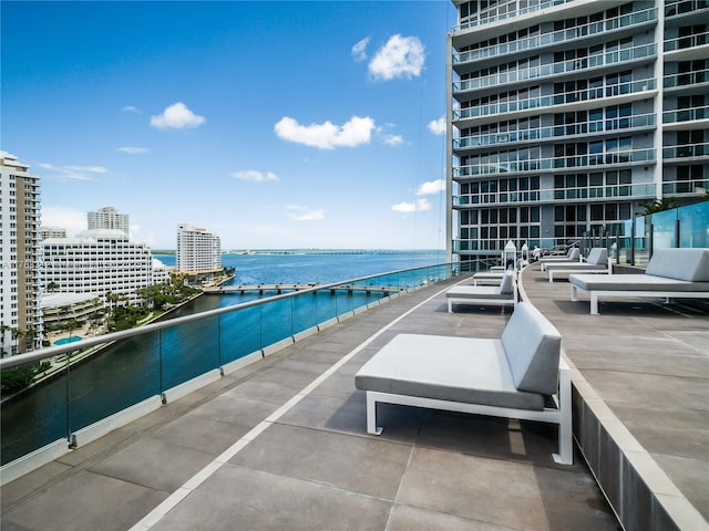 view of swimming pool with a city view and a water view