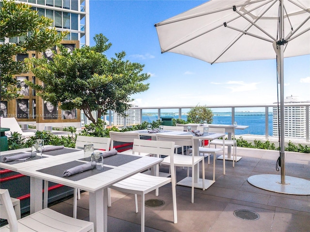 view of patio / terrace with outdoor dining area and a water view
