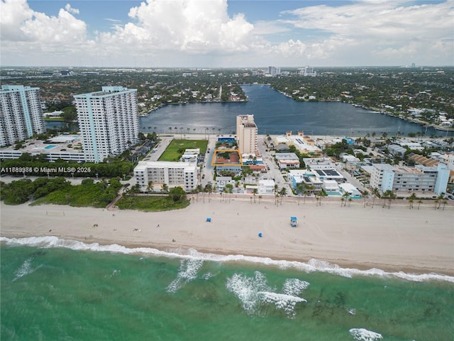aerial view featuring a city view, a view of the beach, and a water view