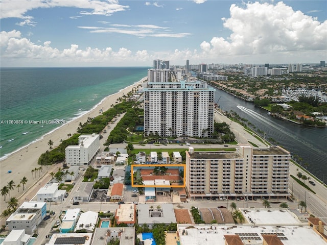 drone / aerial view with a beach view, a water view, and a view of city