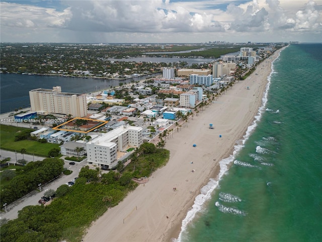 birds eye view of property with a view of city, a beach view, and a water view