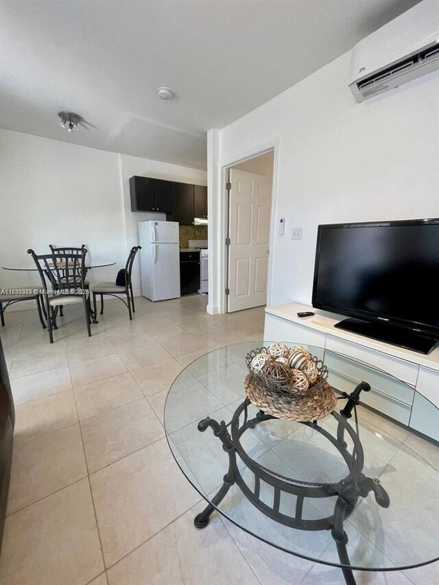 living room featuring light tile patterned flooring and a wall mounted air conditioner