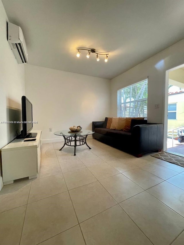 living room with a wall mounted air conditioner and light tile patterned floors