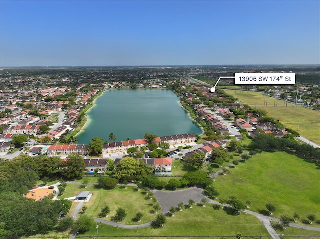 drone / aerial view featuring a residential view and a water view