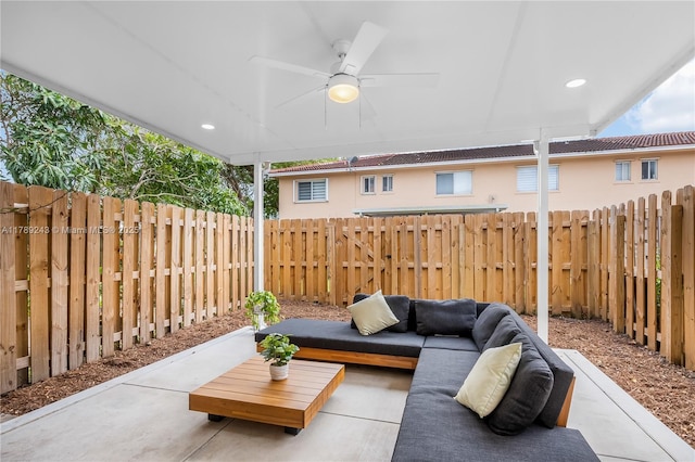 view of patio / terrace featuring a fenced backyard, ceiling fan, and an outdoor living space