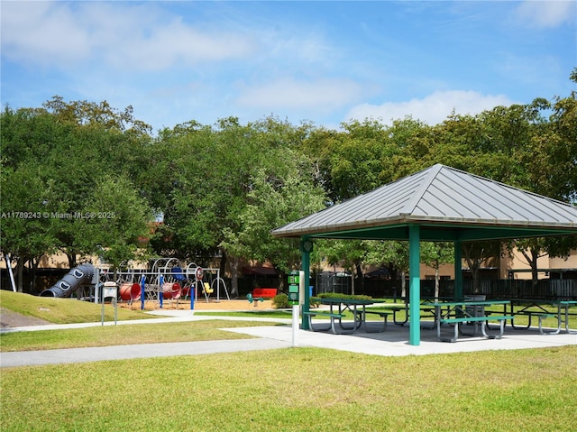 view of property's community featuring a gazebo, playground community, a yard, and fence