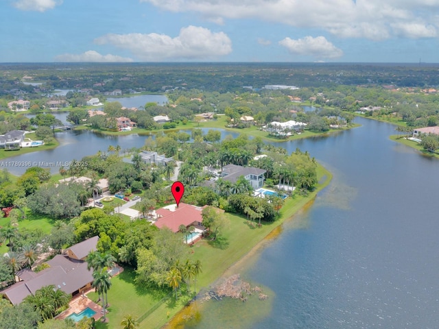 view of property location with a nearby body of water and nearby suburban area