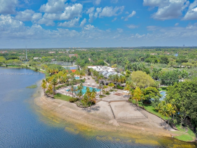 drone / aerial view of a pool and a large body of water
