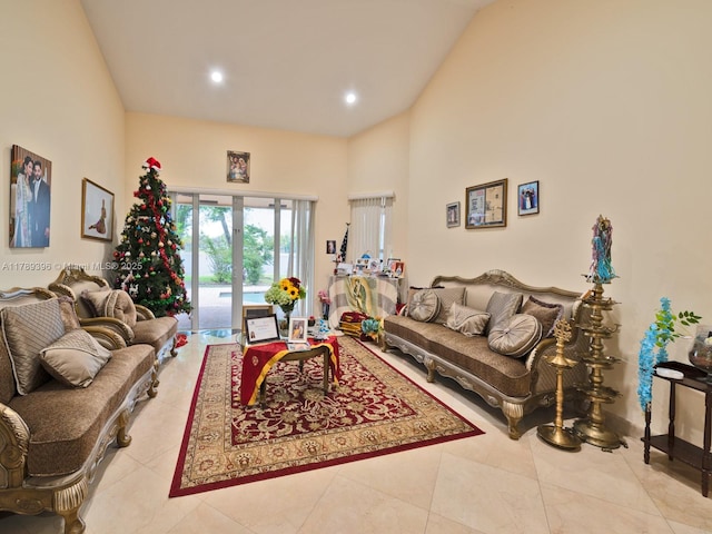 tiled living area featuring recessed lighting and a high ceiling