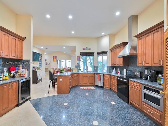 kitchen with stainless steel appliances, wine cooler, wall chimney exhaust hood, recessed lighting, and backsplash