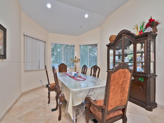 dining room featuring vaulted ceiling, baseboards, light tile patterned floors, and recessed lighting
