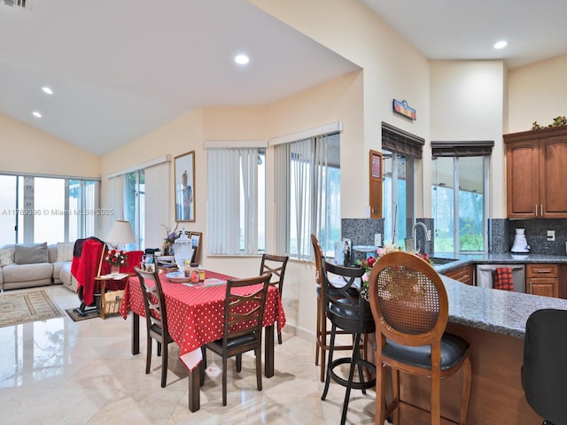 dining room with recessed lighting and vaulted ceiling