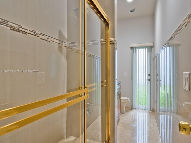 full bathroom featuring toilet and a shower stall