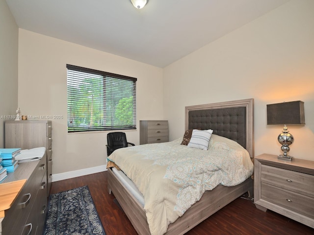 bedroom featuring baseboards and dark wood finished floors