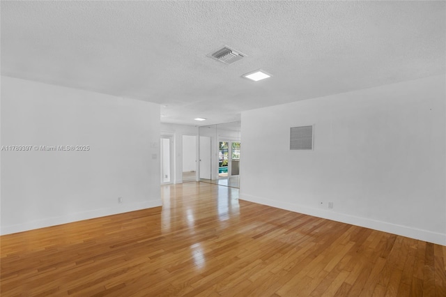 2020 NW 33rd Ct, Oakland Park, FL 33309 - spare room with a textured ceiling, visible vents, and light wood-type flooring