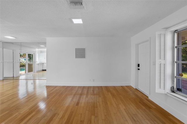 2020 NW 33rd Ct, Oakland Park, FL 33309 - spare room featuring light wood-type flooring, visible vents, and a healthy amount of sunlight