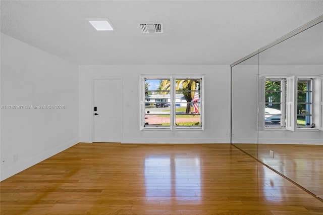 2020 NW 33rd Ct, Oakland Park, FL 33309 - empty room with hardwood / wood-style floors, visible vents, baseboards, and a healthy amount of sunlight