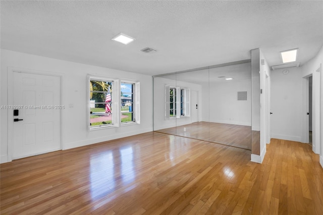 2020 NW 33rd Ct, Oakland Park, FL 33309 - empty room with a textured ceiling, light wood-style floors, visible vents, and baseboards
