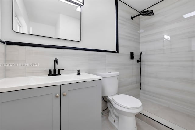 2020 NW 33rd Ct, Oakland Park, FL 33309 - bathroom featuring toilet, vanity, tile walls, tasteful backsplash, and tiled shower