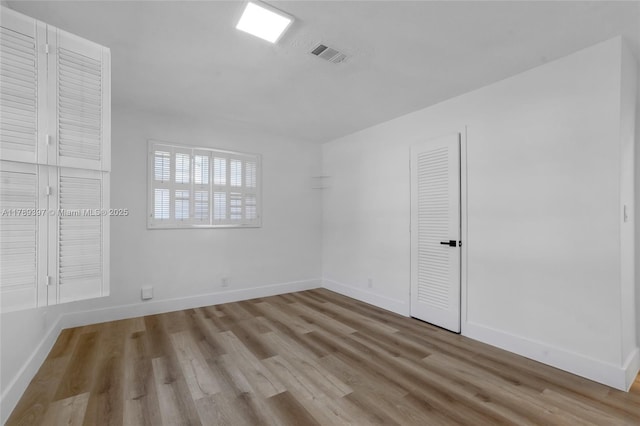 2020 NW 33rd Ct, Oakland Park, FL 33309 - spare room featuring baseboards, wood finished floors, and visible vents