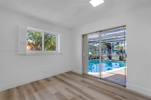2020 NW 33rd Ct, Oakland Park, FL 33309 - unfurnished room featuring a sunroom, light wood finished floors, and baseboards