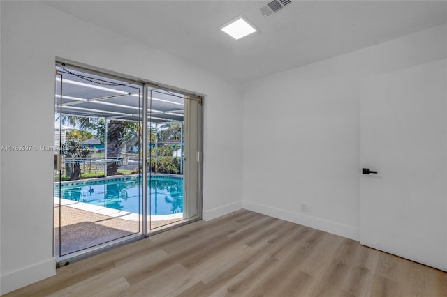 2020 NW 33rd Ct, Oakland Park, FL 33309 - unfurnished room with baseboards, wood finished floors, visible vents, and a sunroom