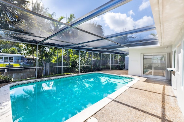 2020 NW 33rd Ct, Oakland Park, FL 33309 - view of swimming pool featuring fence, a fenced in pool, glass enclosure, and a patio