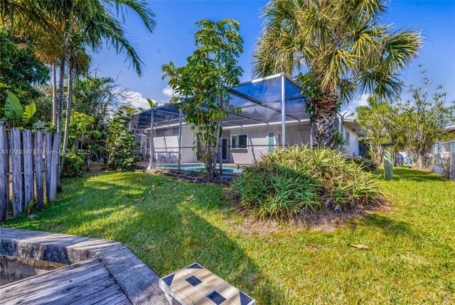2020 NW 33rd Ct, Oakland Park, FL 33309 - view of yard featuring glass enclosure, a fenced in pool, and fence
