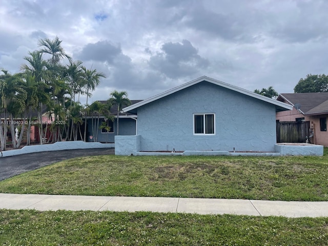 7522 SW 6th St, North Lauderdale, FL 33068 - view of home's exterior with stucco siding and a lawn