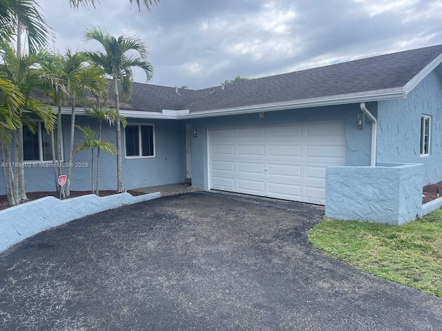 7522 SW 6th St, North Lauderdale, FL 33068 - view of front of home with stucco siding, driveway, a garage, and roof with shingles