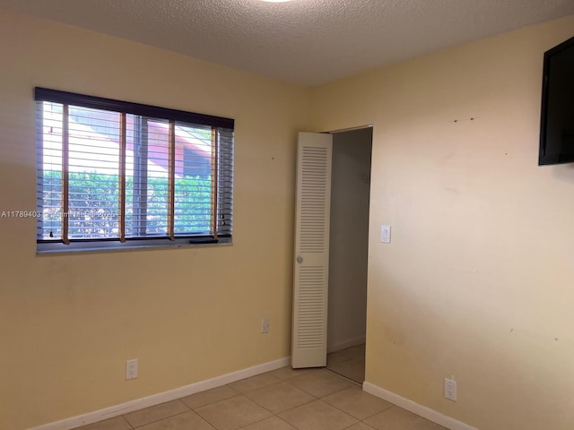 7522 SW 6th St, North Lauderdale, FL 33068 - unfurnished bedroom featuring light tile patterned floors and a textured ceiling