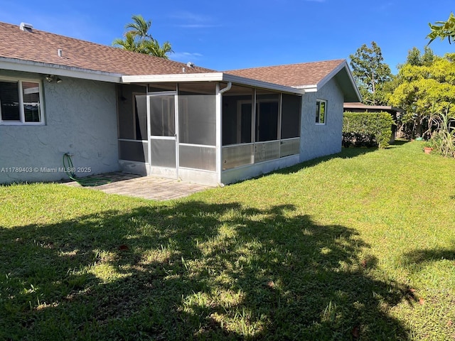 7522 SW 6th St, North Lauderdale, FL 33068 - back of house featuring a sunroom, stucco siding, a yard, and roof with shingles